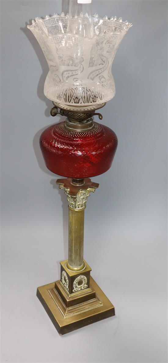 A Corinthian column brass oil lamp with shades
